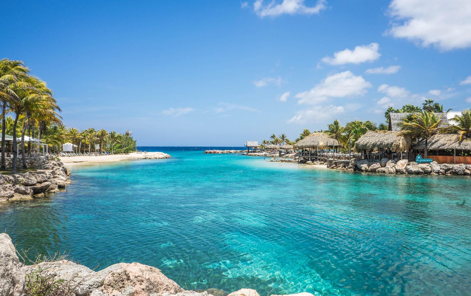 Turquoise lagoon with palapas on Curaçao