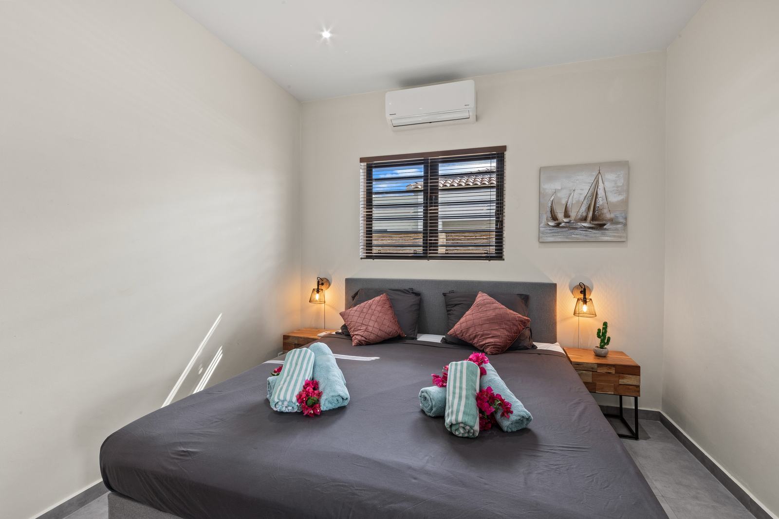 Bedroom with king-size boxspring bed and wooden wardrobe